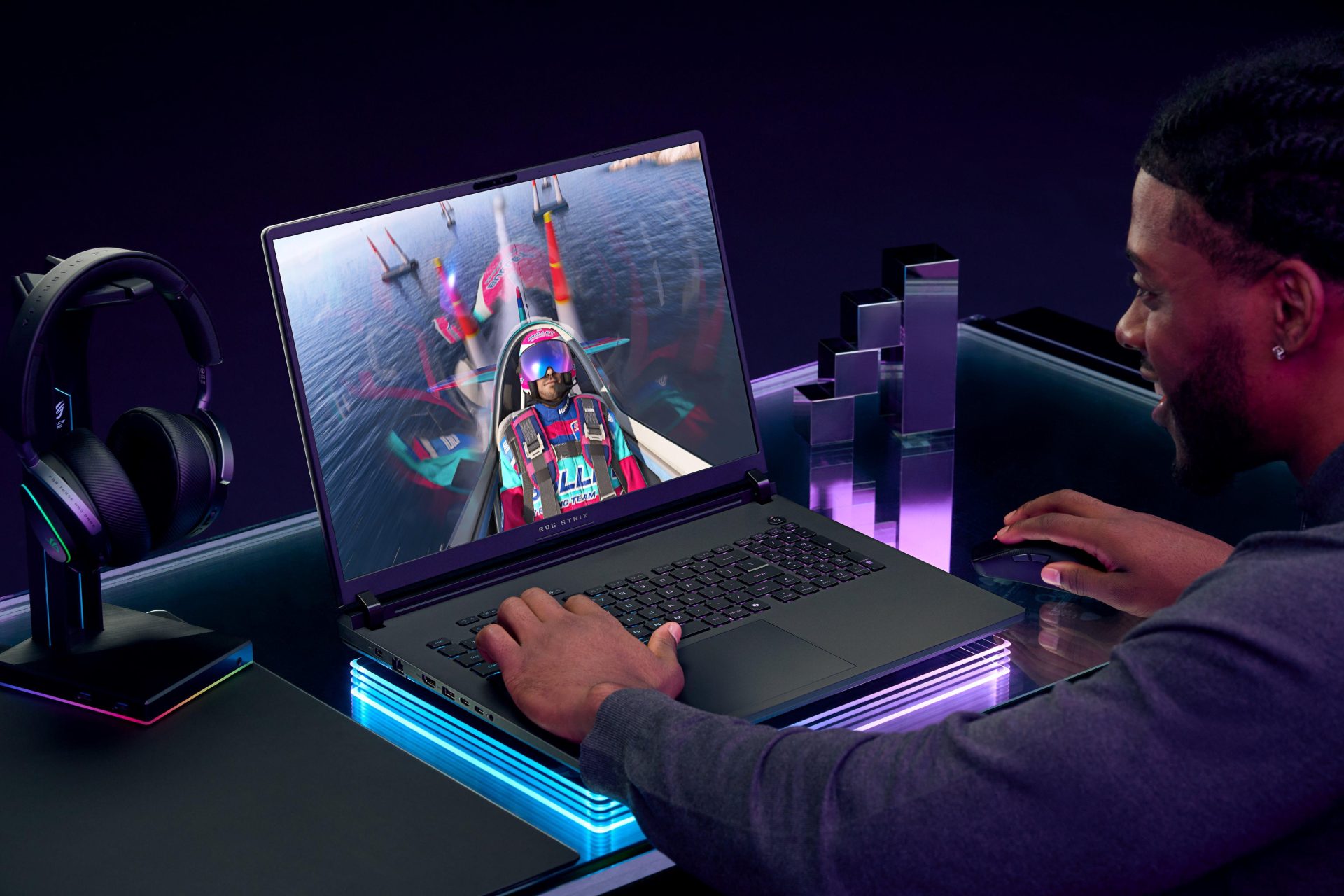 Homem jogando em um notebook gamer ROG Strix Scar 18, exibindo gráficos realistas de um jogo.