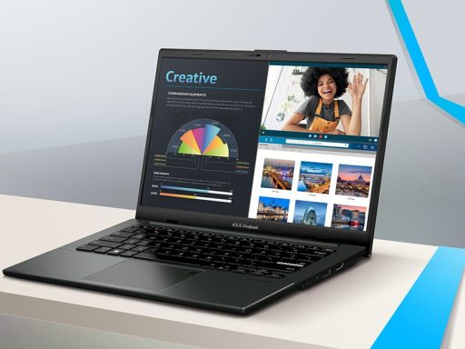 Notebook ASUS Vivobook GO aberto em cima de uma mesa exibindo na tela gráficos com a palavra Creative, uma videochamada e uma galeria de fotos.